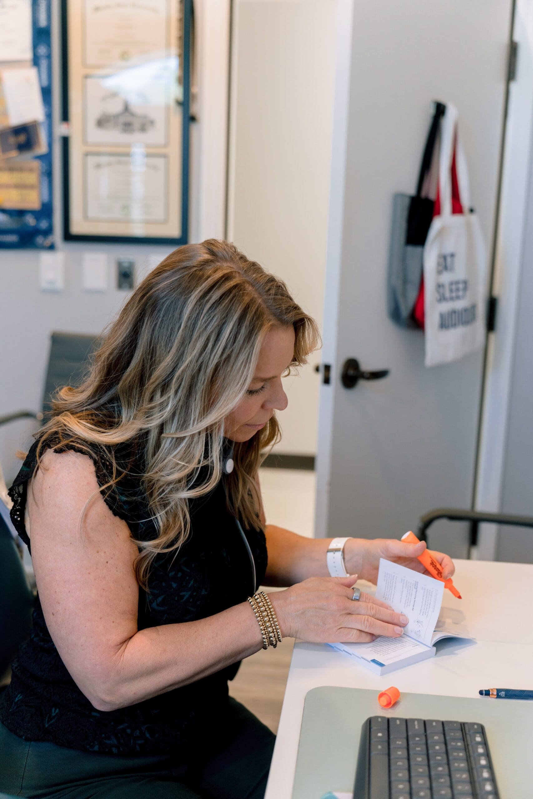 Dr. Alexis Riley, Audiologist in Vero Beach, working at her desk after a tinnitus evaluation.